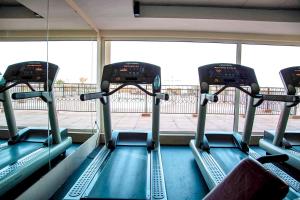 a gym with three seats in front of a window at Sea La View Family Home in Ras al Khaimah