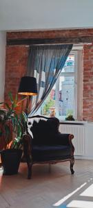 イェレニャ・グラにあるApartament Podwaleの窓付きの客室で、黒いソファが備わります。
