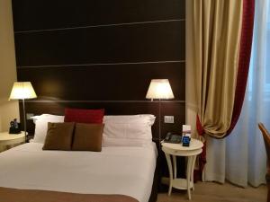 - une chambre avec un lit blanc et une table de chevet dans l'établissement TownHouse 33, à Milan