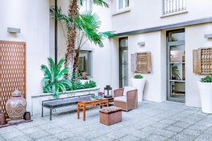 a patio with a bench and a chair and a table at TownHouse 33 in Milan