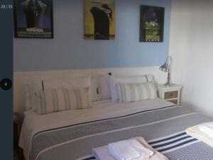 a bedroom with a bed with three pictures on the wall at Cosy apartment with private swimming pool in Santa Cristina d'Aro