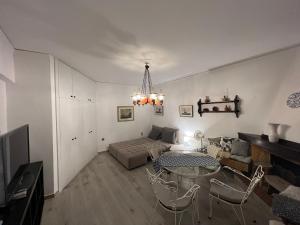 a living room with a table and a couch at Villa Rena In Front of the Sea in Arkoudi