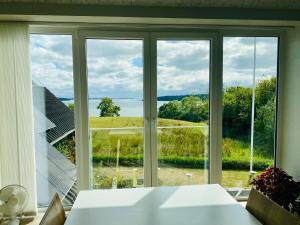 a room with a window with a view of the water at Naturperlen in Rødekro