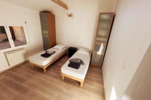 a small room with two beds and a table at PETIT TERME - Piscine - CLIM - Parking in Les Angles Gard