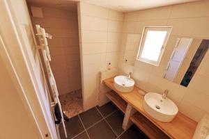 a bathroom with two sinks and a mirror at PETIT TERME - Piscine - CLIM - Parking in Les Angles Gard