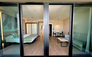 a bedroom with a bed and a table in a room at Hotel Primavera Park in Benidorm