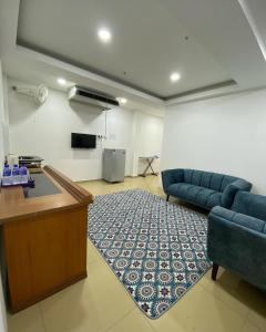 a living room with a couch and a table at D' Anjung Inn in Tangkak