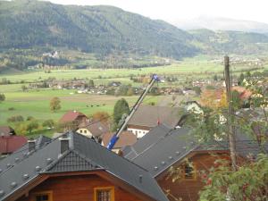 a house with a crane on top of a roof at Hotel Pension Schwaiger in Sankt Margarethen im Lungau