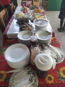 a table with plates and bowls of food on it at Pam de Terra in Calheta de São Miguel