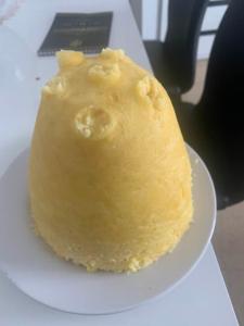 a piece of yellow cake on a white plate at Pam de Terra in Calheta de São Miguel