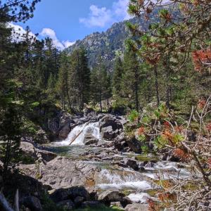 a waterfall in the middle of a mountain stream at Hyper centre, excellent emplacement in Cauterets +2 photos