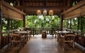 a porch of a restaurant with tables and chairs at The Nature in Siem Reap