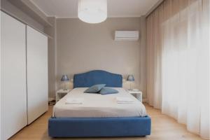 a bedroom with a blue bed with a blue headboard at A due passi dal mare in Trapani