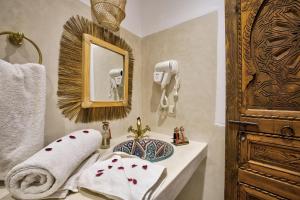 a bathroom with a sink and a mirror at Riad Arabkech in Marrakesh +60 photos