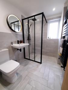 a bathroom with a shower and a toilet and a sink at Self-contained annexe excellent location in Saltdean