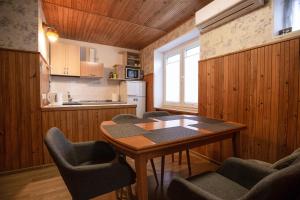 a kitchen with a table and chairs in a room at Poilsis Preiloje in Preila