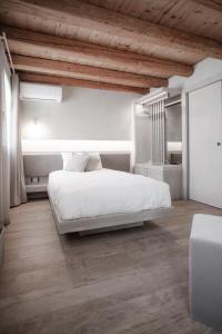 A bed or beds in a room at Locanda MaMaGiò