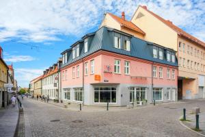 a row of buildings on a street in a city at Forenom Aparthotel Lund in Lund