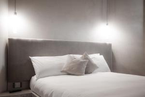 A bed or beds in a room at Locanda MaMaGiò