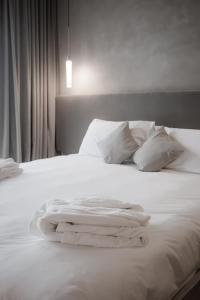 A bed or beds in a room at Locanda MaMaGiò