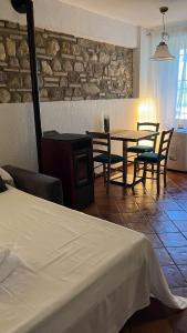 a bedroom with a table and chairs and a fireplace at Cà Vittoria in Desenzano del Garda