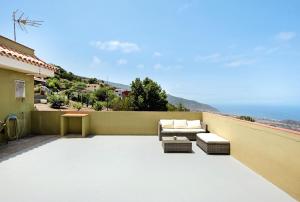 a patio with a couch and a table at House Vochozka in La Orotava