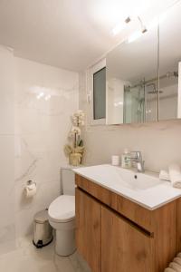 a bathroom with a sink and a toilet and a mirror at MEDLUXE COMFORT APARTMENT in Athens +25 photos