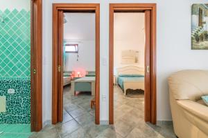 a room with a bedroom and a living room at Villa Chiara in SantʼAntìoco