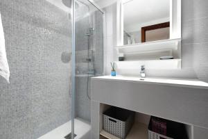 a bathroom with a sink and a shower at Casita Auxilia Bajo in Araya +13 photos