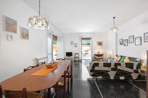 a living room with a table and a couch at Attico di Silvy e Kikka in Arenzano