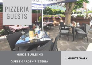 a restaurant with tables and chairs and an umbrella at Apartments CITY Stadion in Linz