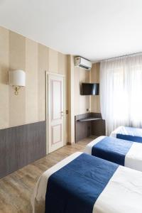 Postel nebo postele na pokoji v ubytování Hotel Garda