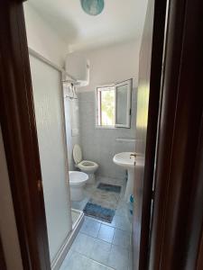 a bathroom with a toilet and a sink at La Mascherada in Ostuni
