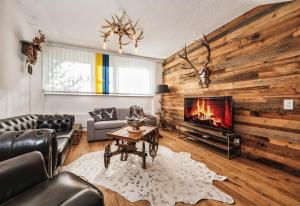 a living room with a couch and a fireplace at Casa Tschierva in Davos