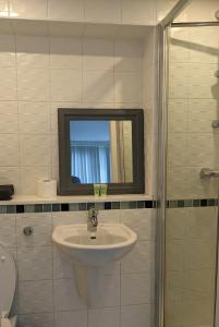 a bathroom with a sink and a mirror at Glasgow City Centre Waterfront Apartment in Glasgow