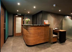 a lobby with a reception desk and a counter at The Lodge On Loch Lomond Hotel in Luss