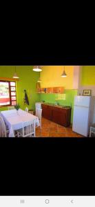 a kitchen with a white table and a refrigerator at Basil Apartments and Rooms in Betina