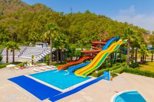 a water slide at a resort with a swimming pool at Fortezza Beach Resort in Hisarönü