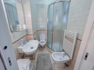a bathroom with a shower and a toilet and a sink at Aragona Luxury Apartment - Fronte Mare in Taranto +15 photos