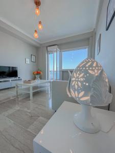 a living room with a sculpture on a table at Aragona Luxury Apartment - Fronte Mare in Taranto