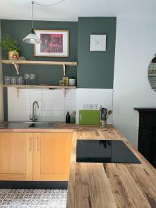 a kitchen with a sink and a counter top at Treetops & Viaducts; open plan two-bed apartment in Walsden +10 photos