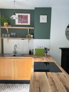 a kitchen with a sink and a counter top at Treetops & Viaducts; open plan two-bed apartment in Walsden