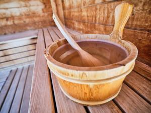 a wooden bowl and two wooden spoons sitting on a table at Hotel Planai by Alpeffect Hotels in Schladming