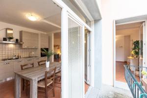 a kitchen and dining room with a wooden table at Palazzo Ghibellina by Rental in Florence in Florence