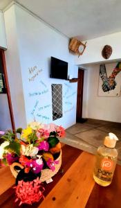 a room with a table with a basket of flowers at Villa c'est la vie in Nosy Komba