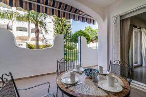 a dining room with a table and chairs and a window at LXR Marysol II 2BDR. Apt in Benalmádena