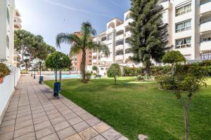 a park in front of a large apartment building at LXR Marysol II 2BDR. Apt in Benalmádena