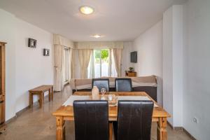 a living room with a wooden table and chairs at LXR Marysol II 2BDR. Apt in Benalmádena