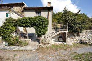a stone house with a staircase in front of it at Ca' Kira in Molini di Triora