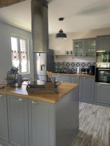 a kitchen with a sink and a counter top at Le Jardin de Juliette in Gournay